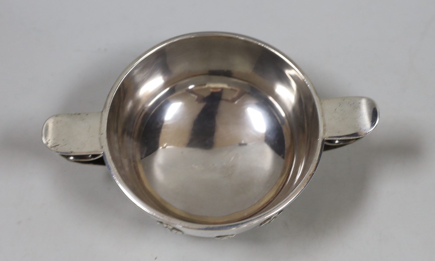 A George V silver two handled bowl, with cut card decoration, Goldsmiths & Silversmiths Co Ltd London, 1926. diameter 16.3cm over handles, 8.4oz.